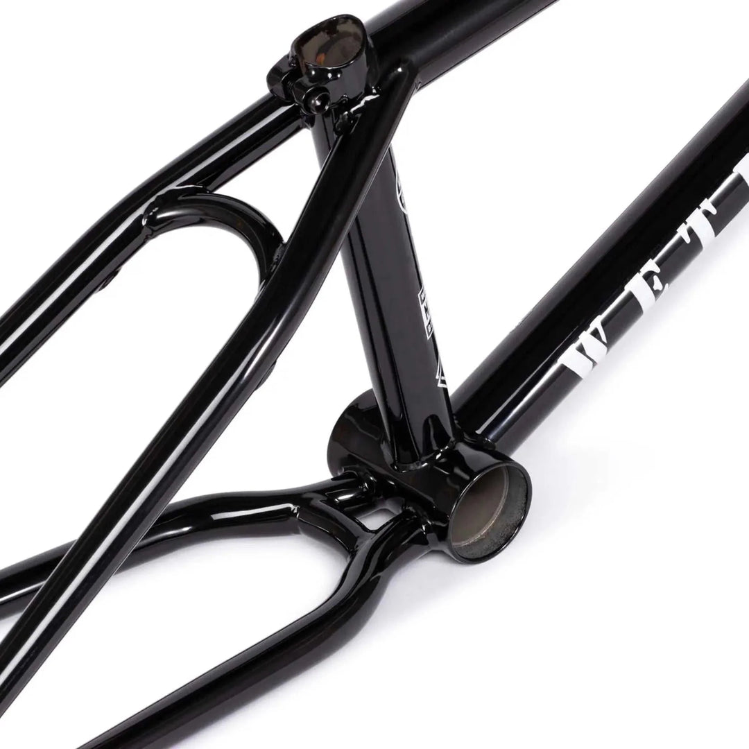 Close-up of black WETHEPEOPLE MESSAGE FRAME BMX bike frame made from lightweight 4130 chromoly tubing with technical park setup features